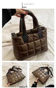 Detail view of brown quilted down puffer tote bag with glossy finish and shoulder straps
