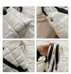 Detail view of white quilted down bag showing nylon fabric texture and black straps