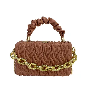 Quilted caramel brown crossbody bag with gold chain strap and pleated top handle