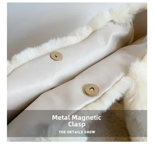 Detail view of golden magnetic buckles on cream plush faux fur tote bag interior