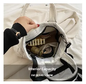 Internal capacity of white quilted tote bag showing cosmetics and inner zipper pocket
