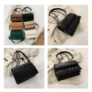 Detailed view of V-quilted faux leather crossbody bags with accordion side structure