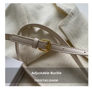 Close-up of adjustable golden buckle and leather strap with precise stitching detail