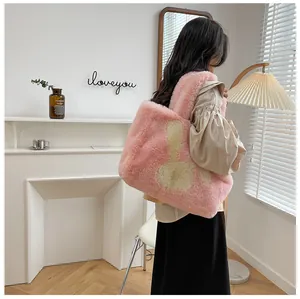 Detail of pink plush tote bag featuring cute rabbit ears design and fuzzy texture
