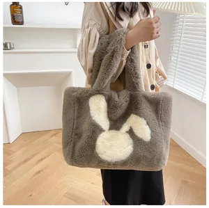 Detail of soft gray faux fur tote bag featuring a cute white rabbit patch and sturdy handles