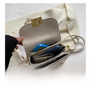 Top view of cream white shoulder bag showing internal compartments and storage capacity