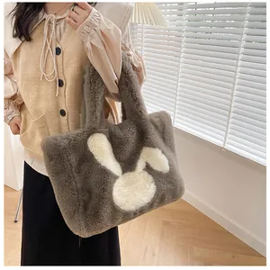 Detail of the soft faux fur tote bag with a cute white rabbit pattern for winter fashion