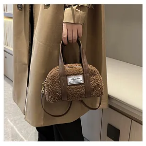 Brown teddy plush mini Boston bag with faux leather trim carried by model in khaki coat