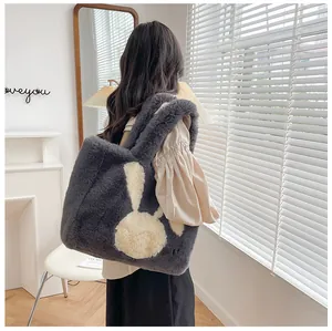 Detail of the soft faux fur texture and cute rabbit motif on the large grey tote bag