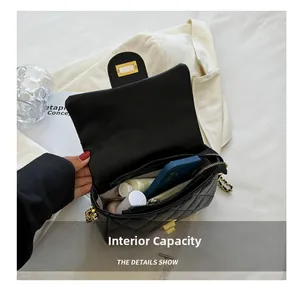 Detailed internal capacity view of black quilted leather shoulder bag with gold hardware