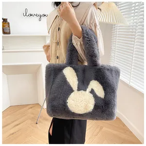 Macro shot of fluffy dark grey faux fur tote bag with a white cartoon rabbit pattern