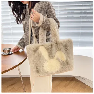 Detail of soft plush tote bag featuring a cute rabbit pattern and contrasting handles