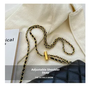 Close-up of adjustable gold ball buckle and quilted chain strap on a black shoulder bag
