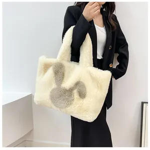 Detail of the soft faux fur tote bag with a cute grey plush bunny patch on the front
