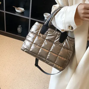 Padded down cotton tote bag with bronze metallic quilting and adjustable strap for women