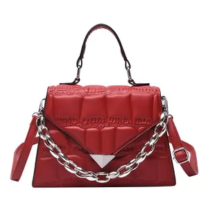 Red quilted faux leather handbag with silver triangle buckle and chunky chain strap