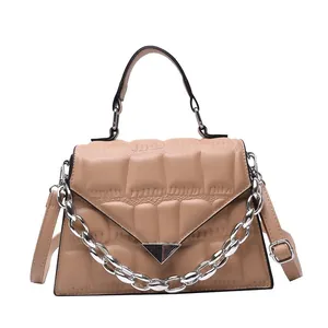 Light brown quilted leather crossbody bag with silver chain and metal buckle detail