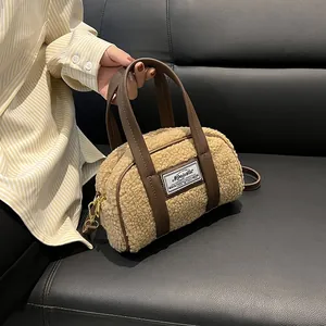 Plush lamb wool handbag in beige with dark brown leather straps and gold metal hardware