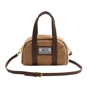Plush faux shearling handbag in brown with leather handles and adjustable shoulder strap