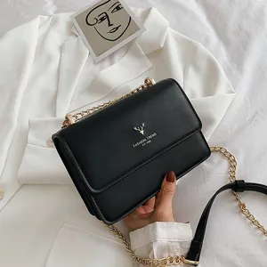 Minimalist black pebble leather chain crossbody bag with golden deer emblem and trendy design