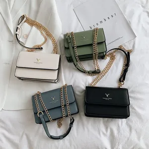 Minimalist leather crossbody chain bags in cream, green, blue and black with metal deer logo
