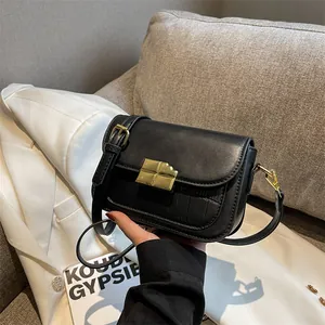 Chic black crocodile embossed leather crossbody bag with elegant gold rectangular lock