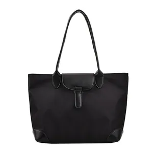 Minimalist black oxford fabric tote bag with leather trim and sturdy handles for women