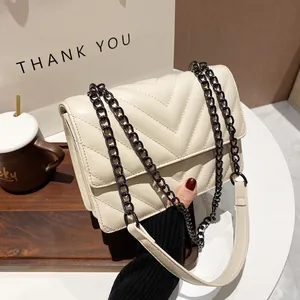 Classic creamy white quilted crossbody bag with stylish V-stitch pattern and chain strap