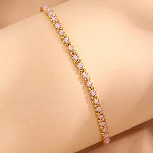 Detailed macro view of a light purple braided rope bracelet with 18k gold beads