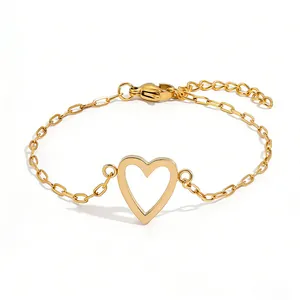 Detail of adjustable gold hollow heart bracelet with minimalist paperclip link chain