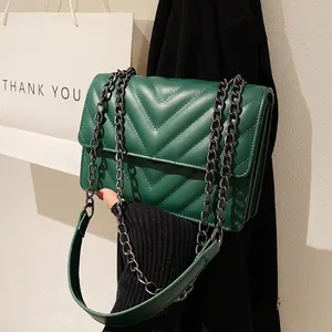 Vintage dark green quilted crossbody bag with V-shaped stitching and chain strap