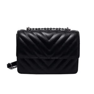Classic black leather crossbody bag with V-shaped quilting and metal chain strap