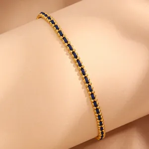 Detail of woven blue cord bracelet with 18k gold plated stainless steel beads