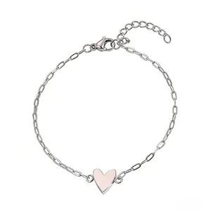 Macro view of adjustable stainless steel bracelet featuring a pink enamel heart charm