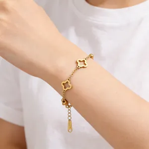 Detail of clover bracelet with gold plating, extender chain and small metal tag