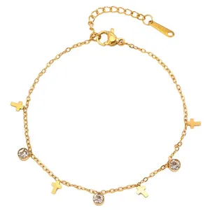 Gold stainless steel bracelet with cross charms and sparkling zircon stones on white background