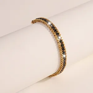 Detail of gold chain bracelet featuring double rows and pave set black faceted gemstones
