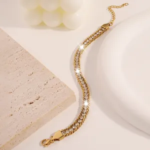 Close-up of golden titanium steel bracelet with rhinestones on a minimalist stone tray