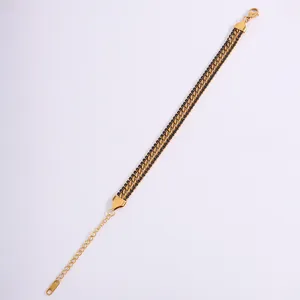 Detailed macro of gold-plated stainless steel layered Cuban chain bracelet with black crystals