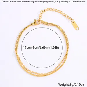 Detail of double-layer gold stainless steel bracelet with leaf charm and lobster clasp