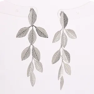 Detail of silver long leaf tassel earrings with textured veins on white background