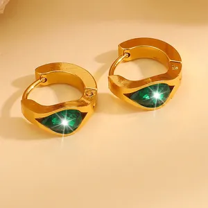 Detail of gold-plated stainless steel earrings featuring a pear-cut emerald green zircon