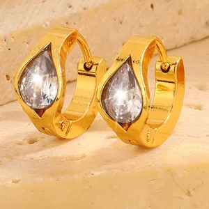 Detailed macro view of gold plated earrings featuring a teardrop shaped zircon stone
