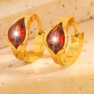 Detail of gold-plated stainless steel hoop earrings featuring red pear-shaped zircon stones