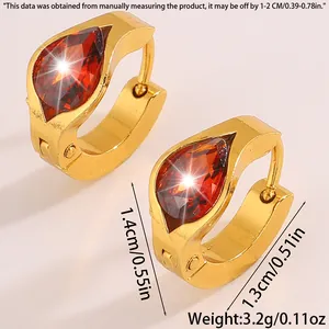 Macro view of gold-plated earrings with red pear-cut zircon and size measurements