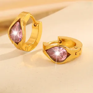 Detailed close-up of gold stainless steel hoop earrings with pear-cut pink zircon stones