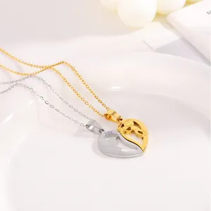 Detail of silver and gold heart puzzle pendants with boy and girl engravings on fine chains