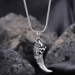 Macro shot of silver dragon head pendant in titanium steel with a sleek snake chain