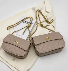 Close-up of khaki quilted crossbody bag with gold chain strap and turn-lock closure