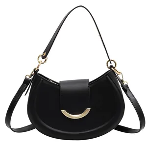 Minimalist black crescent shoulder bag with smooth texture and gold hardware detail